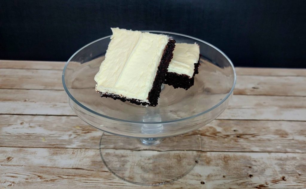 A piece of chocolate cake in a glass bowl.