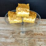 Peanut butter cookie bars on a clear glass plate.