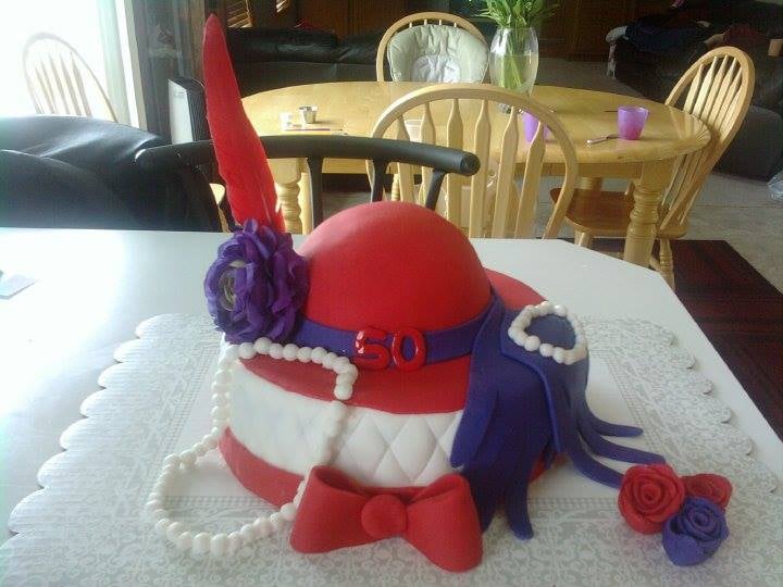 Custom cake decorated with a hat and pearls. Made by Nan's Nummies