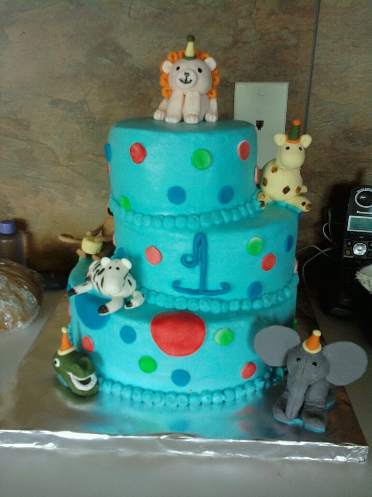 Custom blue cake with animals on it. Made by Nan's Nummies