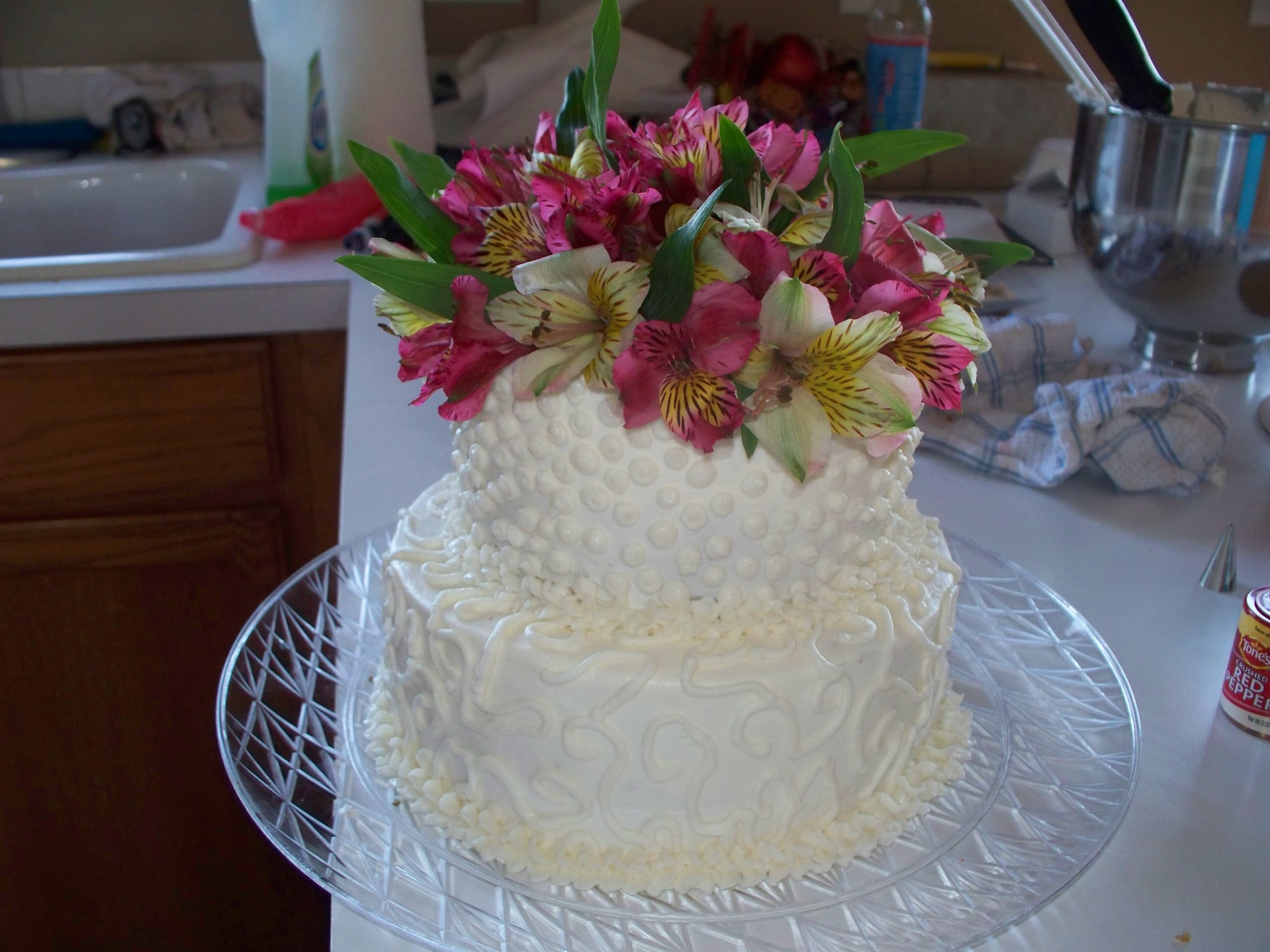 Custom white cake with pink flowers on top. Made by Nan's Nummies
