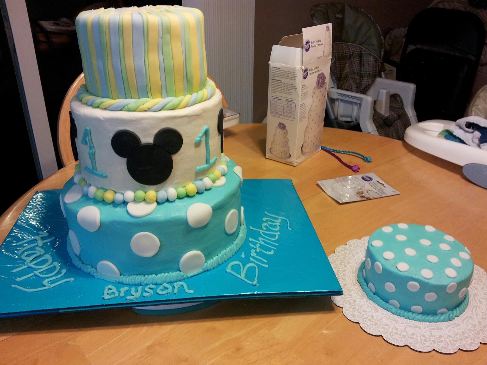 Custom cake with a mickey mouse on top.