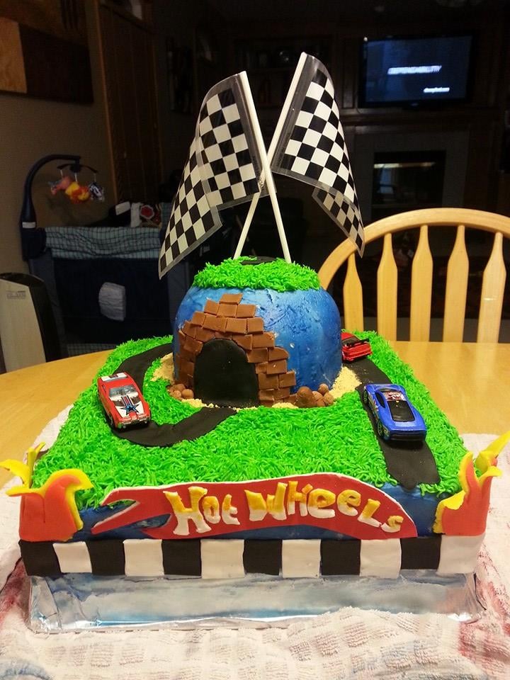Custom hot wheels cake with a checkered flag on top. Made by Nan's Nummies