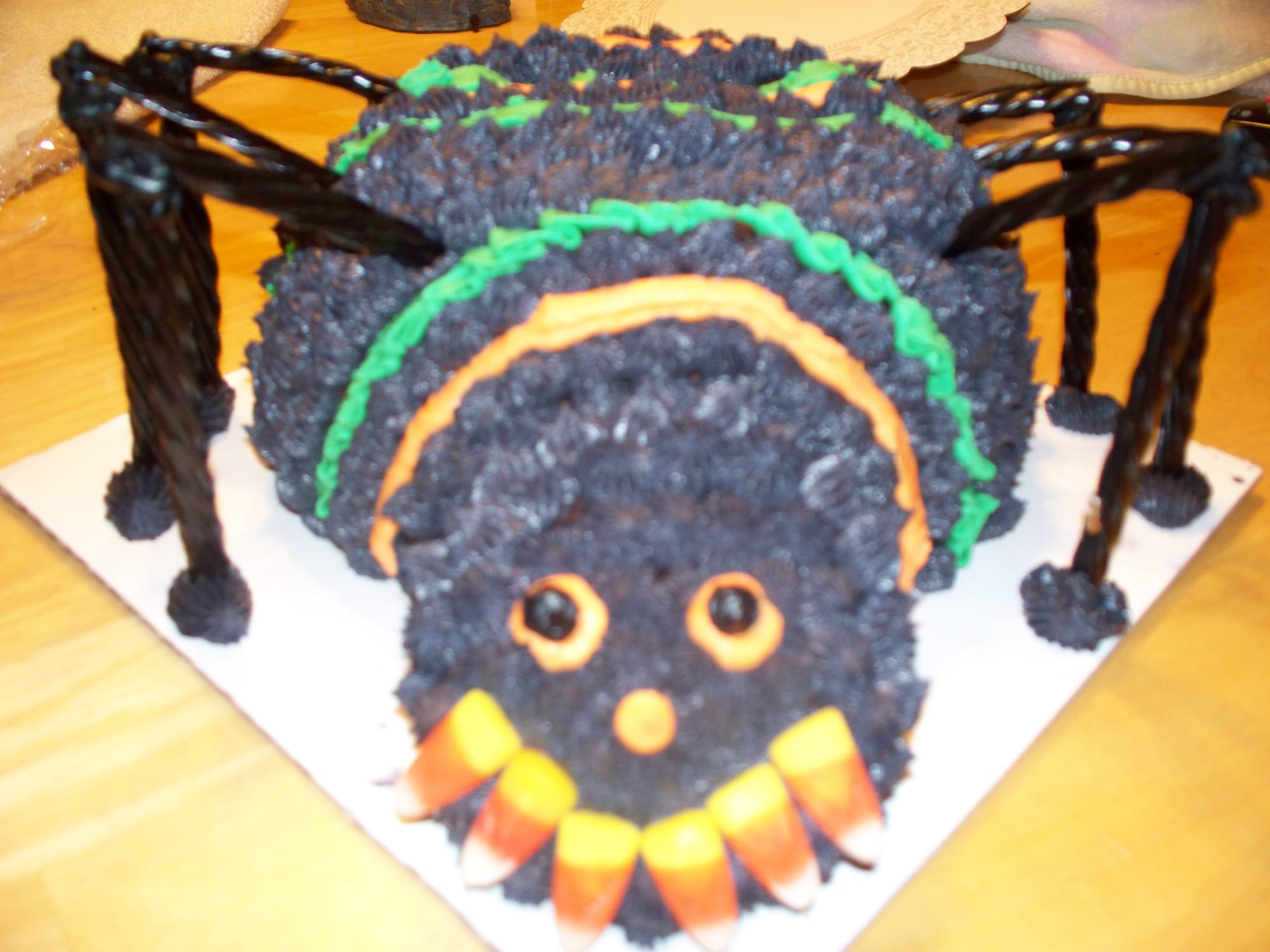 Custom spider cake on a table. Made by Nan's Nummies