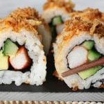 Japanese sushi rolls with chopsticks.