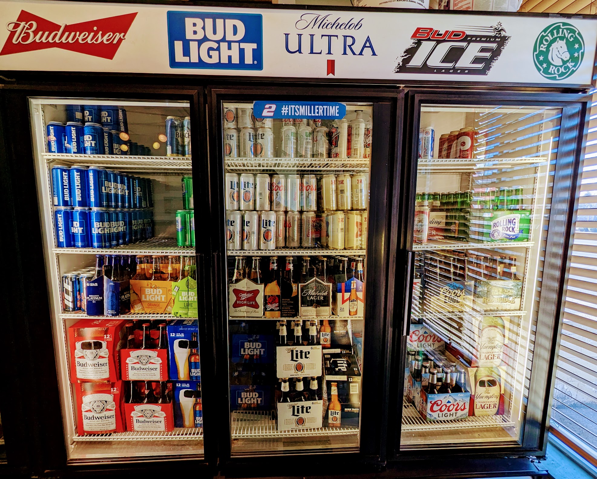A refrigerator full of beer and soda.