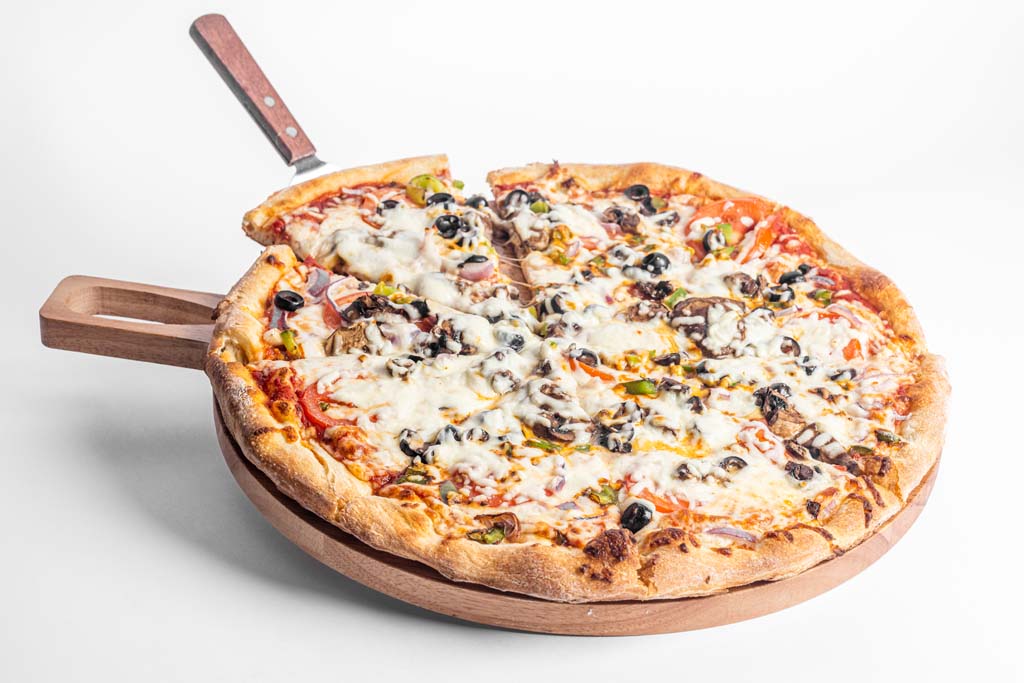 A pizza on a wooden plate.