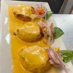A plate topped with three cheese stuffed chicken breasts.