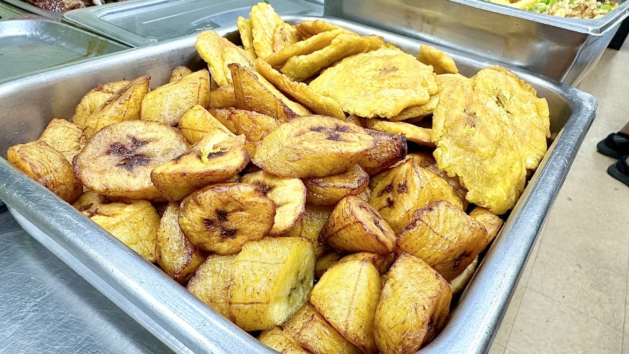 A tray of fried bananas on a table.
