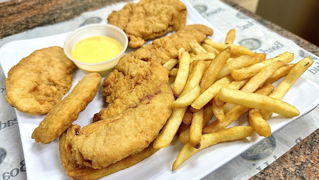 A plate with fish, fries and dipping sauce.