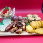 A tray with a variety of food on it.