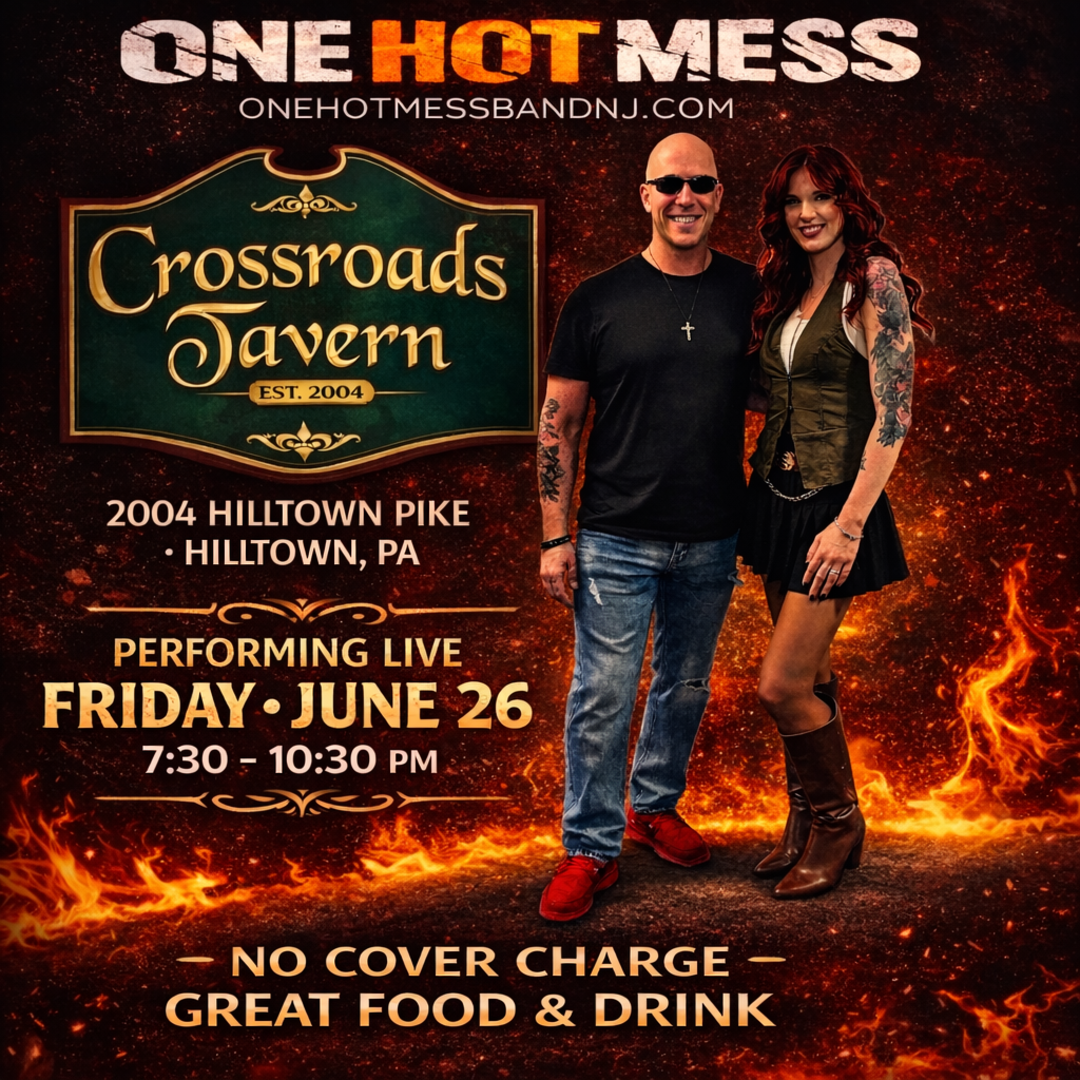A man and woman stand in front of a Crossroads Tavern sign, advertising a live performance by One Hot Mess on Friday, June 26, 7:30–10:30 PM, with no cover charge.