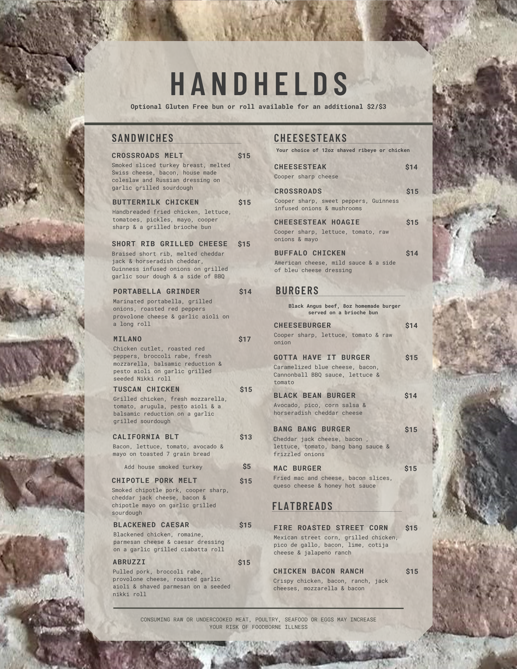 Menu titled "Handhelds" displayed on a stone wall background, listing sandwiches, cheesesteaks, burgers, and flatbreads with prices and brief descriptions of each item.